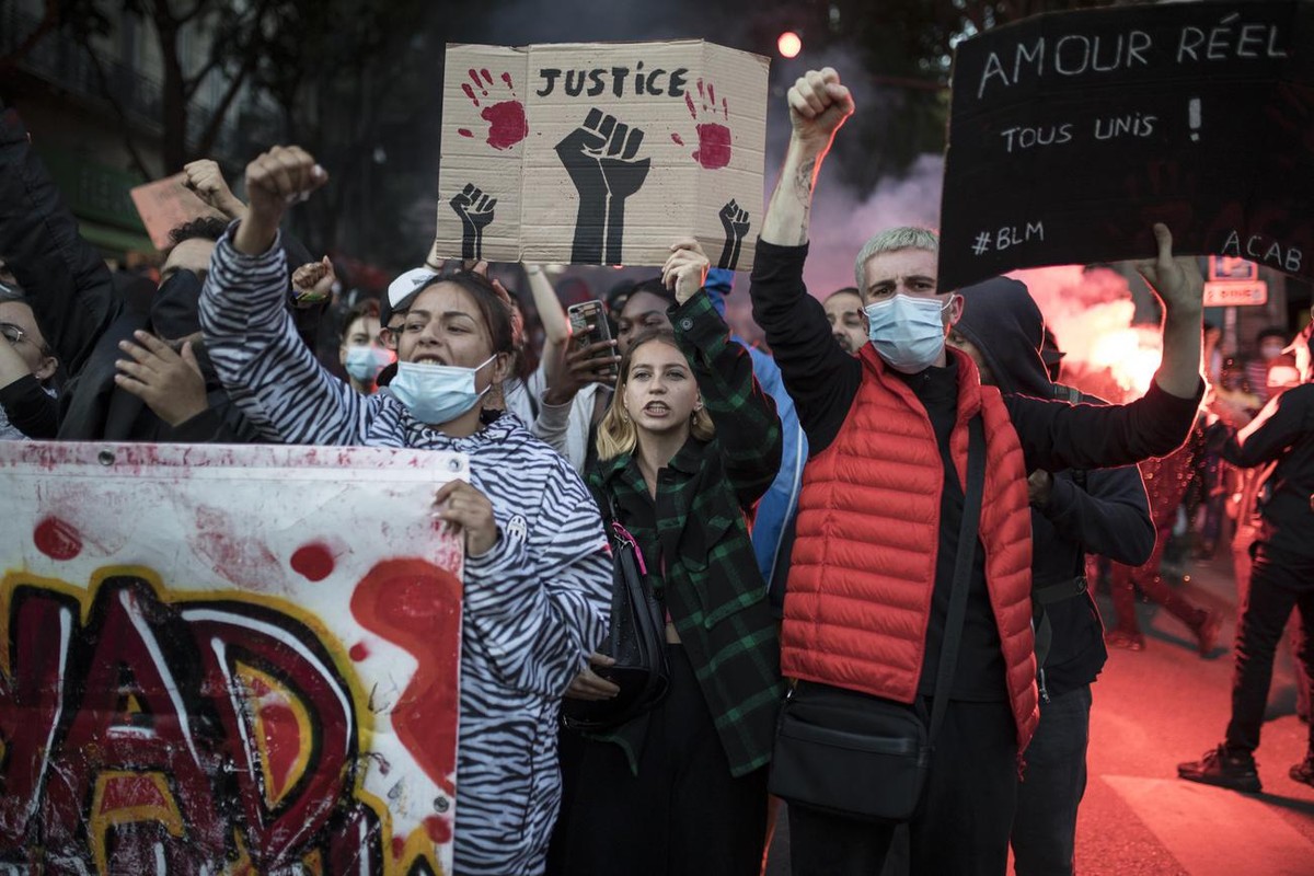 Protesters raise their fists during a march against police brutality and racism in Marseille, France, Saturday, June 13, 2020, organized by supporters of Adama Traore, who died in police custody in 20 ...