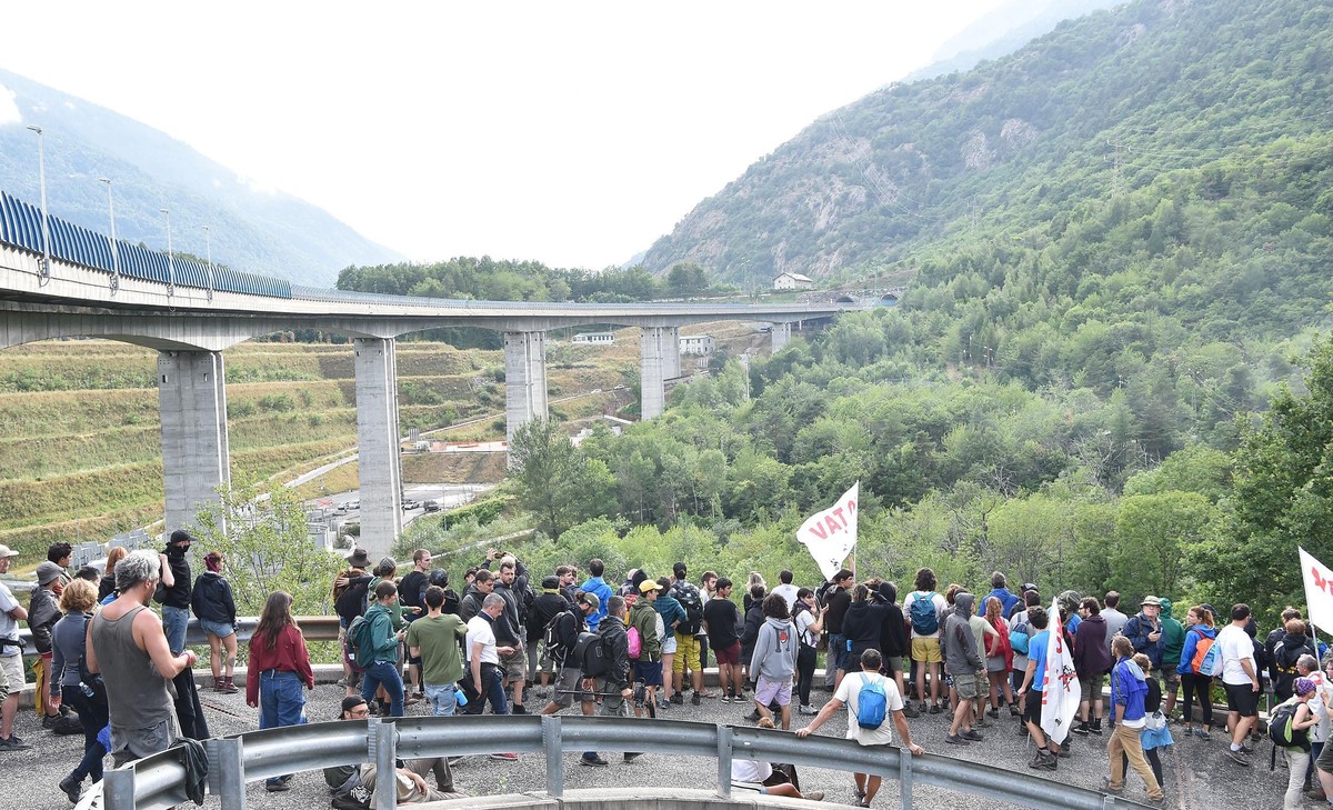 epa07744977 Members of NO TAV movement march during a rally towards the Chiomonte TAV worksite in Susa Valley, Piedmont Region, northern Italy, 27 July 2019. Italy would incur 'huge costs' t ...