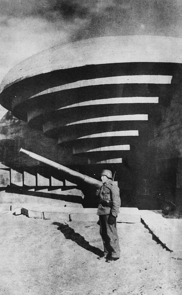 A German soldier stands guard outside a fortified artillery emplacement on the Atlantic Wall, built by Nazi Germany, along the Atlantic coast of Europe to defend against Allied invasion, circa 1944. ( ...