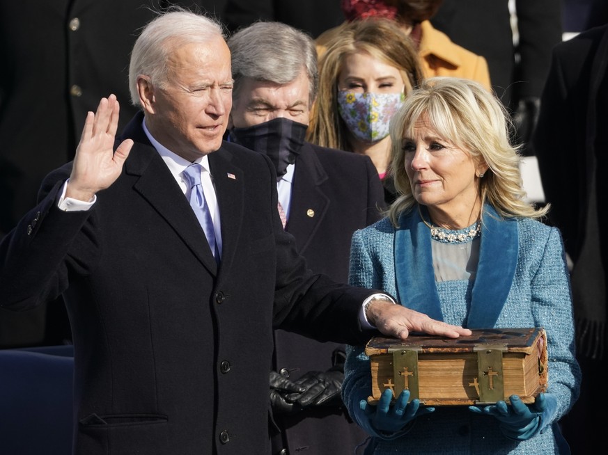 FILE - Joe Biden is sworn in as the 46th president of the United States by Chief Justice John Roberts as Jill Biden holds the Biden family Bible during the 59th Presidential Inauguration at the U.S. C ...