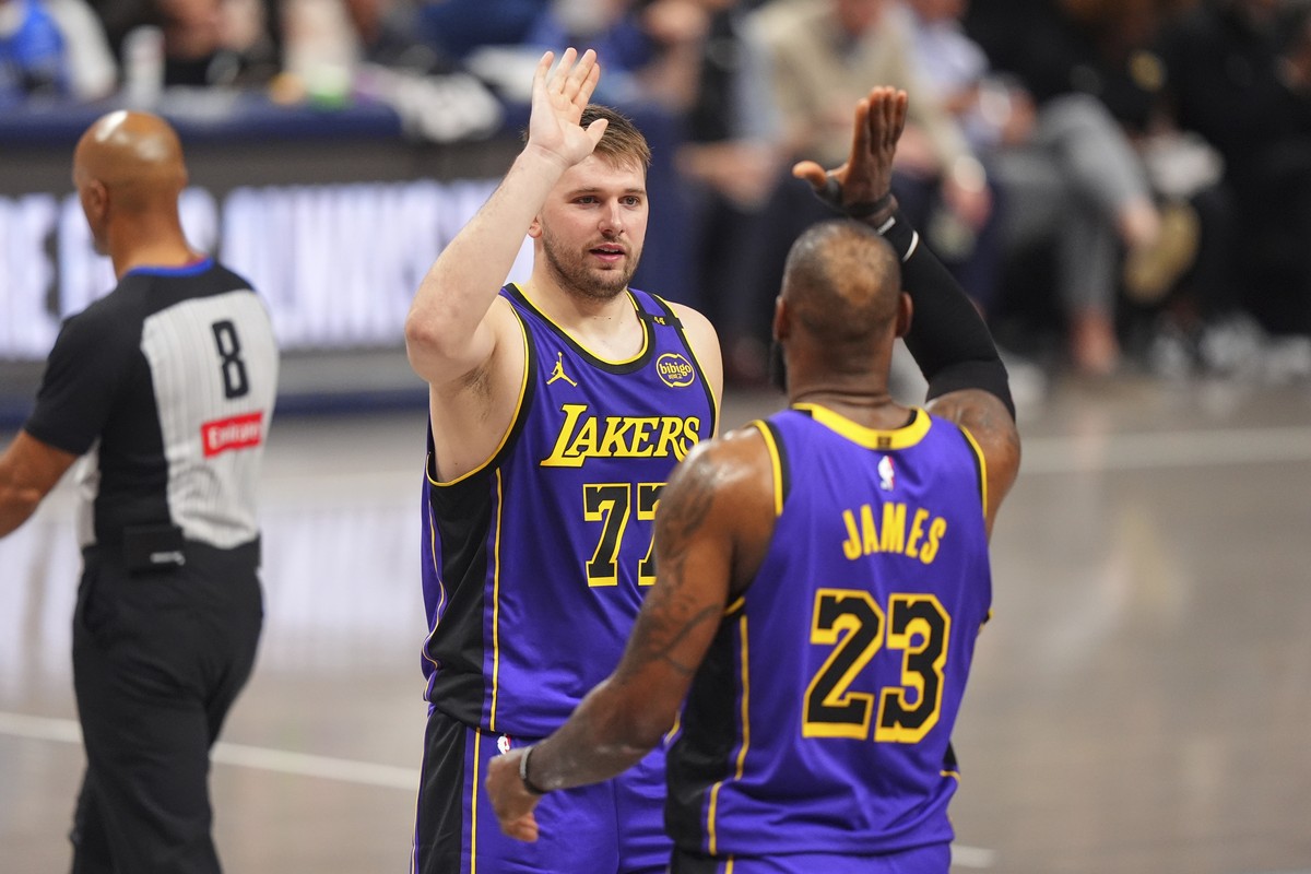 Los Angeles Lakers' Luka Doncic (77) and LeBron James (23) celebrate in the second half of an NBA basketball game against the Dallas Mavericks in Dallas, Wednesday, April 9, 2025. (AP Photo/LM Ot ...
