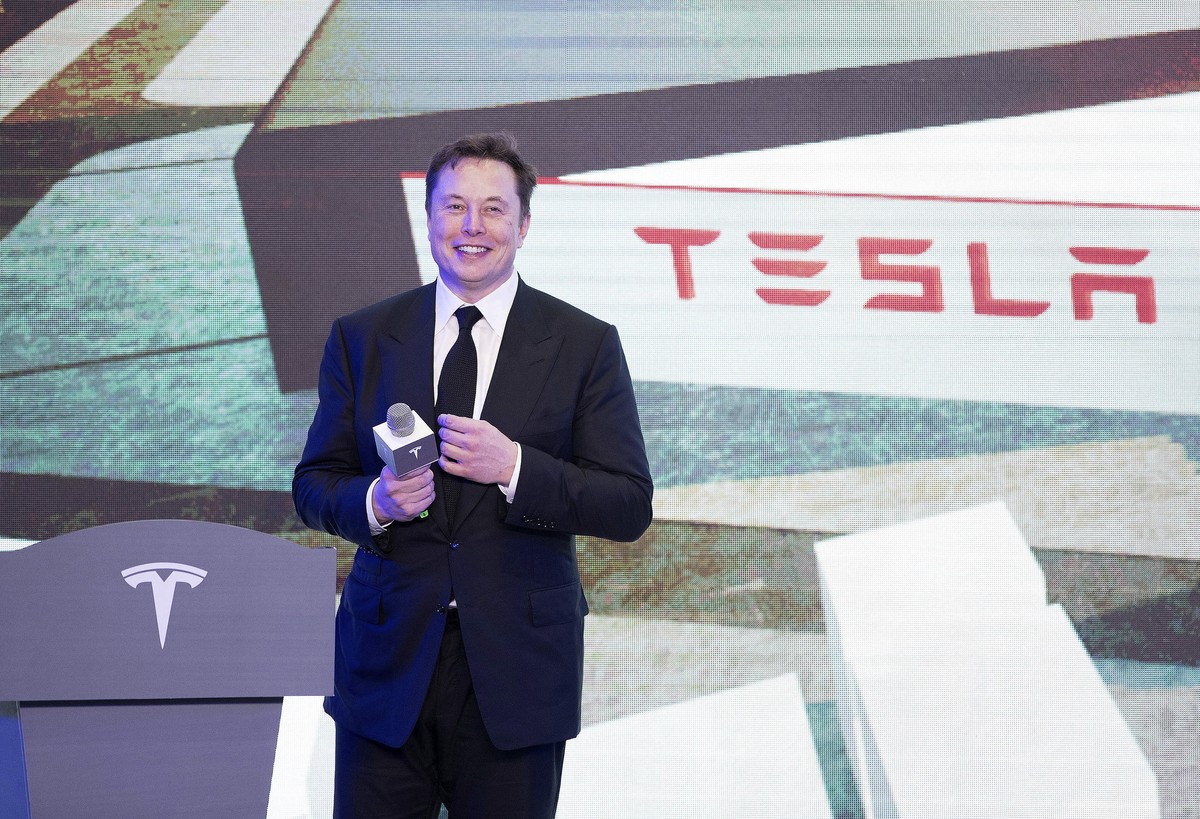 In this photo released by China's Xinhua News Agency, Tesla CEO Elon Musk speaks at a delivery ceremony for the first Tesla Model 3 cars made at Tesla's Shanghai factory in Shanghai, Tuesday ...