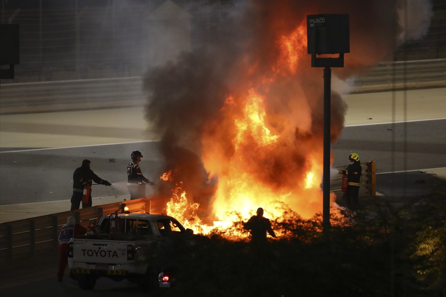 epa08850821 Flames on the crash site of French Formula One driver Romain Grosjean of the Haas F1 Team during the start of the Formula One Grand of Bahrain on the Bahrain International Circuit in Sakhi ...