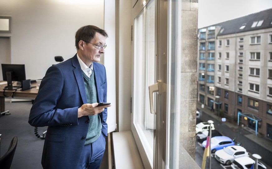 Karl Lauterbach, Federal Minister of Health, looks out of his office shortly before his participation in the video conference of the German government&#039;s expert council on the Corona pandemic in B ...