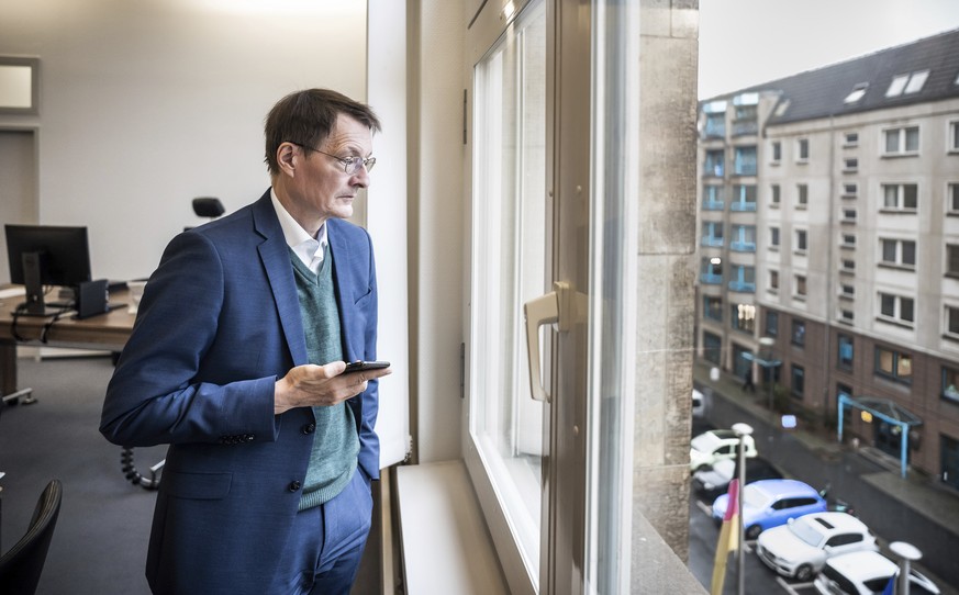 Karl Lauterbach, Federal Minister of Health, looks out of his office shortly before his participation in the video conference of the German government&#039;s expert council on the Corona pandemic in B ...