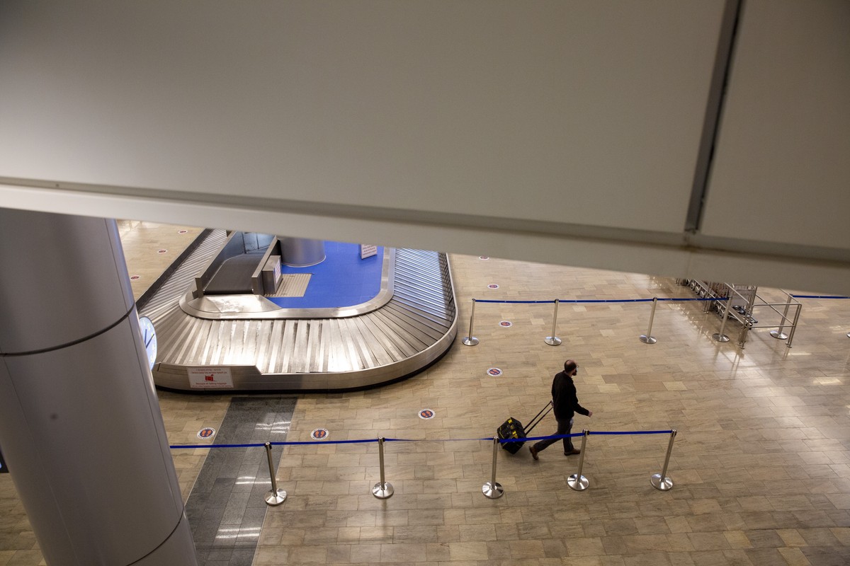 A passenger wears a face mask to protect from coronavirus in the arrival hall in Ben Gurion Airport near Tel Aviv, Israel, Sunday, Jan. 24, 2021 during a nationwide lockdown to curb the spread of the  ...