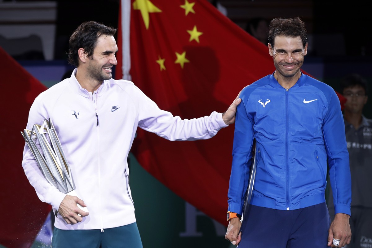 Roger Federer of Switzerland, left, gestures with Spain's Rafael Nadal after winning their men's singles final match in the Shanghai Masters tennis tournament at Qizhong Forest Sports City T ...