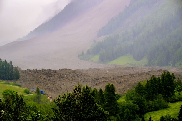 A large avalanche with a mixture of ice, rock, snow and water reach the valley floor is pictured in Wiler after the Birch glacier collapsing above Blatten, Switzerland, Wednesday, May 28, 2025. (KEYST ...