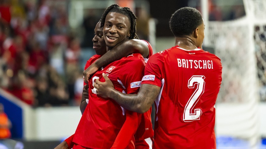 epa13285769 Switzerland's Johan Manzambi, centre, celebrates his 2-0 goal with teammates Switzerland's Winsley Boteli, left, and Switzerland's Sascha Britschgi, right, during the UEFA N ...