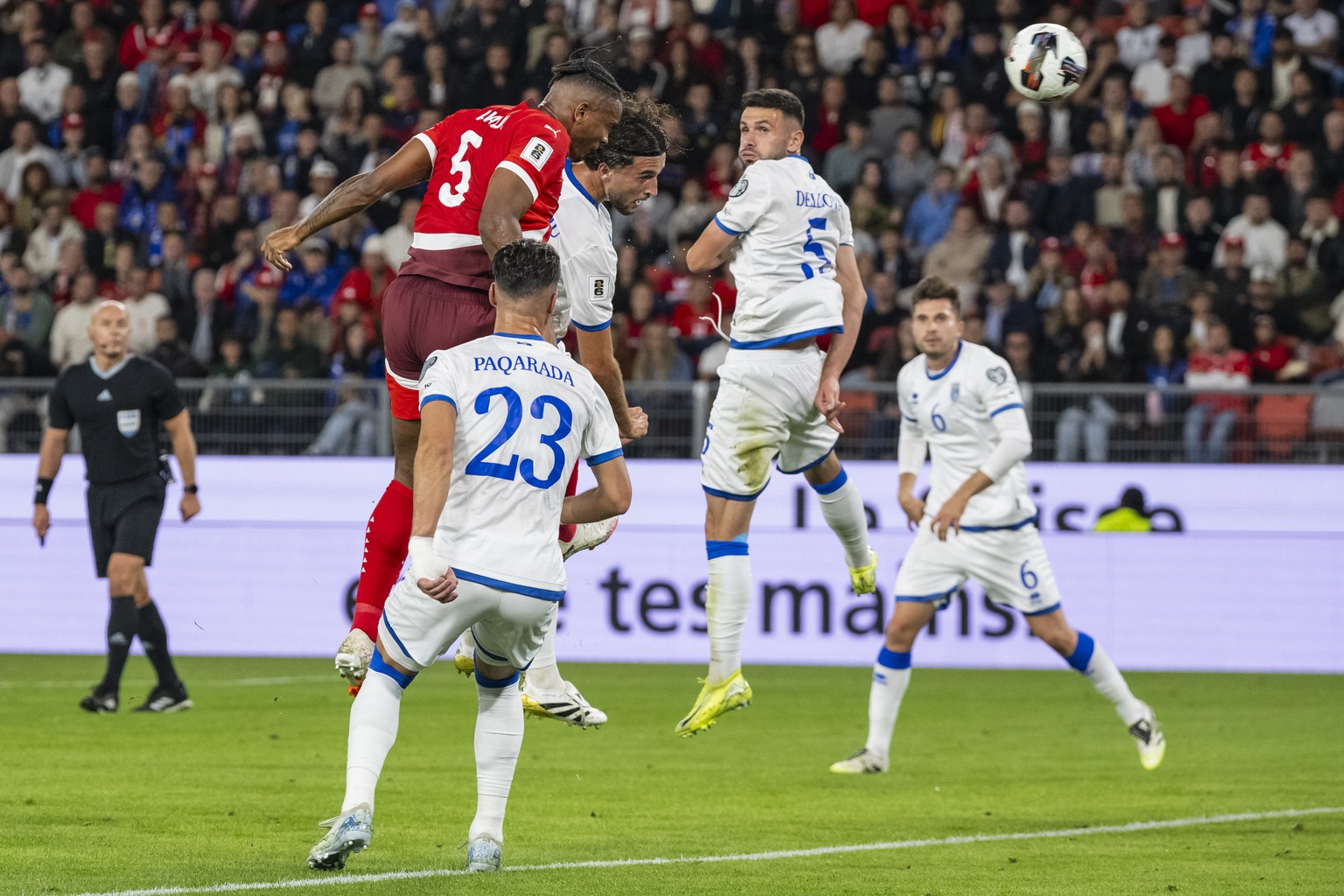 epa12355522 Switzerland's Manuel Akanji, top left, scores with a header the 1-0 against from right, Kosovo's Elvis Rexhbecaj, Lumbardh Dellova, Leon Avdullahu, and Leart Pacarada, during the ...