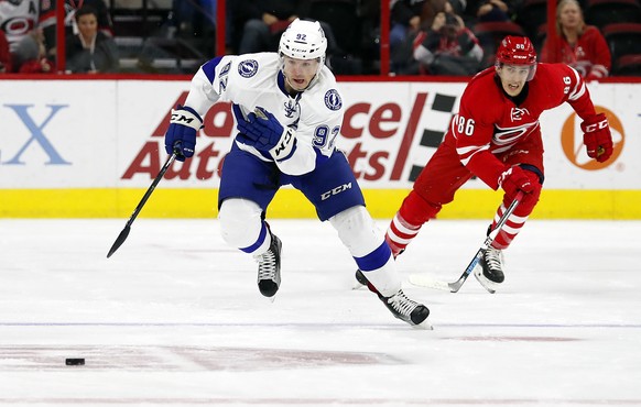 Tampa Bay Lightning&#039;s Joel Vermin (92) takes the puck down the ice after taking it away from Carolina Hurricanes&#039; Teuvo Teravainen (86) during the first period of an NHL hockey game, Sunday, ...