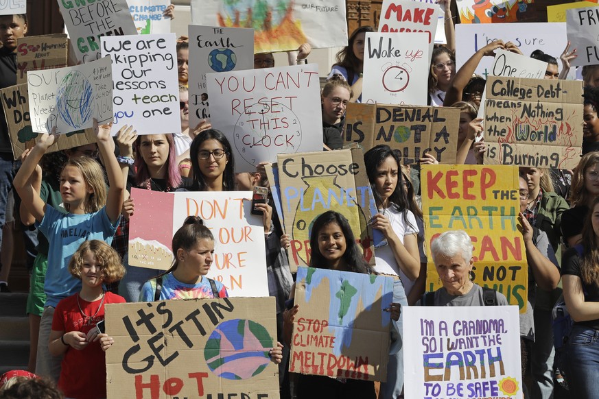 Students and guests gather on the steps of the Statehouse during a climate change protest, Friday, Sept. 20, 2019, in Indianapolis. Across the globe, hundreds of thousands of young people took to the  ...