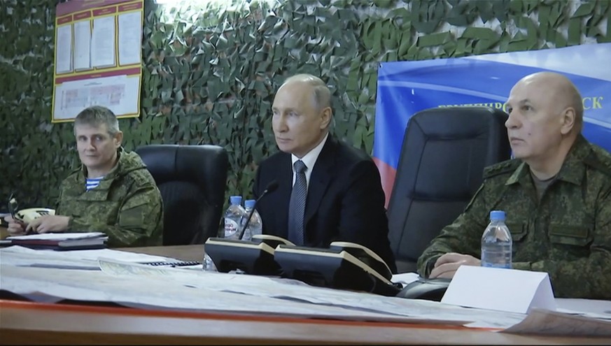 In this photo taken from video released by Russian TV Pool on Tuesday, April 18, 2023, Russian President Vladimir Putin, centre, attends a meeting with commander of the grouping of troops &quot;Dnepr& ...