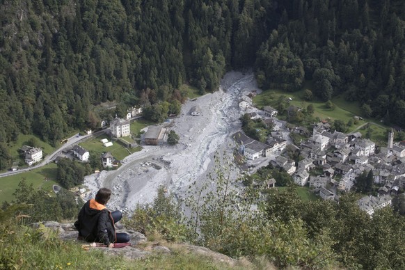 Eine Person blickt gedankenversunken auf die Aufraeumarbeiten in Bondo, aufgenommen am Sonntag, 17. September 2017, von Soglio aus. Am Piz Cengalo im suedbuendnerischen Bergell war es am Freitagabend  ...