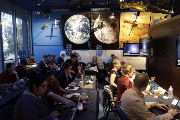 Journalists gather at NASA's Jet Propulsion Laboratory awaiting the landing of InSight on Mars Monday, Nov. 26, 2018, in Pasadena, Calif . A NASA spacecraft is just a few hours away from landing on Mars. The InSight lander is aiming for a Monday afternoon touchdown on what scientists and engineers hope will be a flat plain on the red planet. (AP Photo/Marcio Jose Sanchez)
