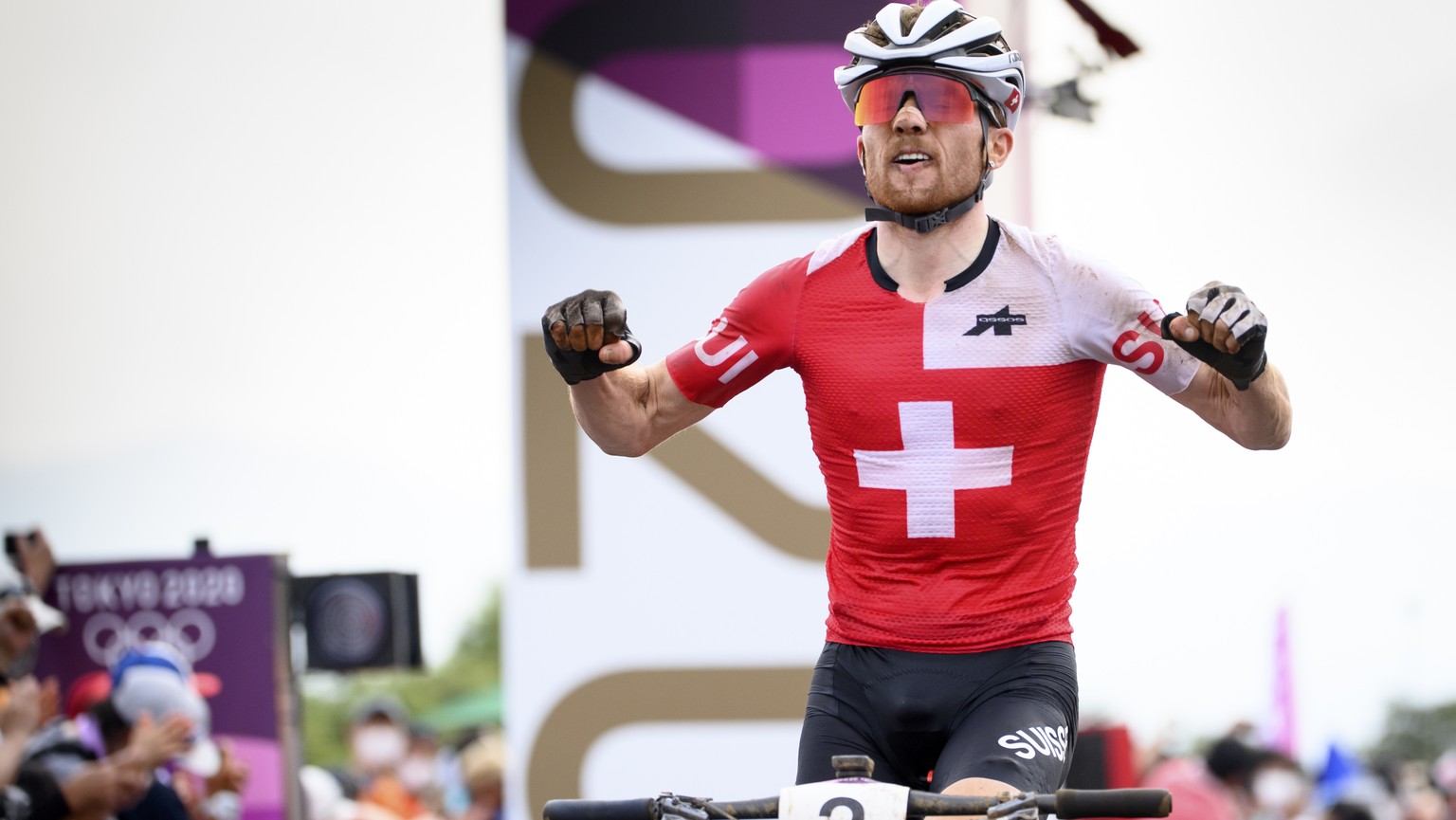 Silver medal winner Mathias Flueckiger of Switzerland celebrates as he crossing the finish line during the men&#039;s Cross-country Mountain Bike, MTB, race at the 2020 Tokyo Summer Olympics in Izu ne ...