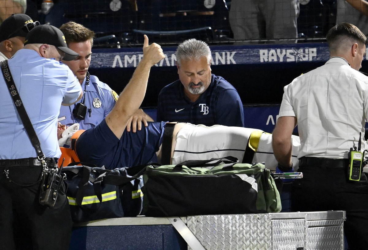 Tampa Bay Rays' Hunter Bigge gives a thumbs up as paramedics tend to him after being hit by a foul ball while in the dugout during the seventh inning of a baseball game against the Baltimore Orio ...