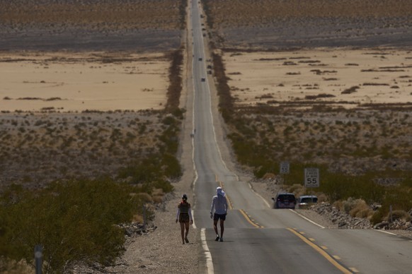 Danny Westergaard, right, competes with pacing help from daughter Meagan Westergaard during the Badwater 135 Ultramarathon, Tuesday, July 8, 2025, in Death Valley National Park, Calif. (AP Photo/John  ...