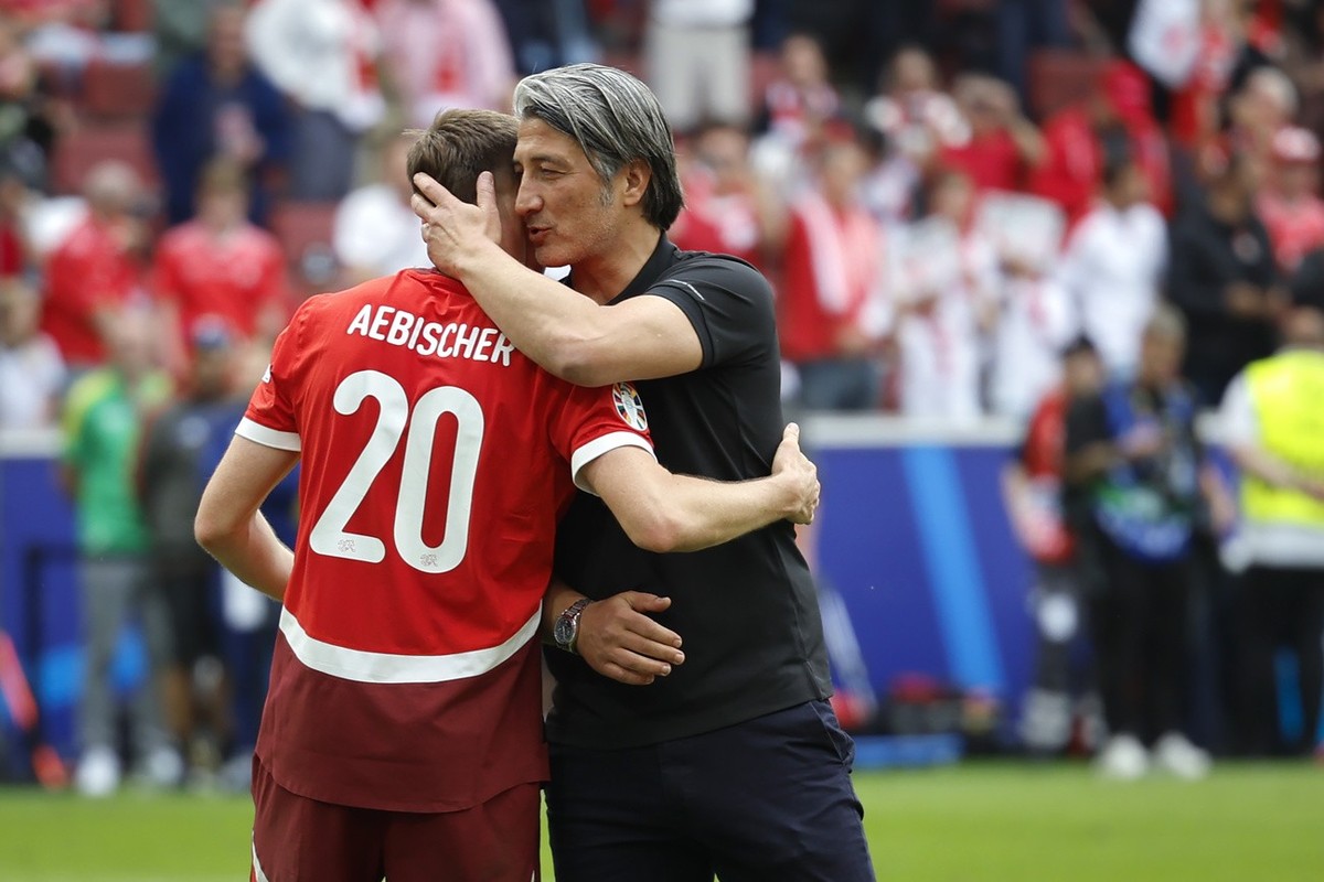 Switzerland's head coach Murat Yakin, right, celebrates with his player Michel Aebischer after winning a Group A match between Hungary and Switzerland at the Euro 2024 soccer tournament in Cologn ...