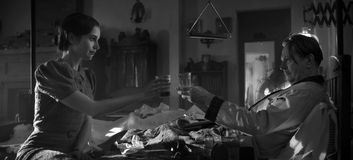 In this image released by Netflix, Lily Collins, left, and Gary Oldman appear in a scene from "Mank." Available on Netflix Friday, ��Mank�� is one of the year���s very best films, both a tri ...