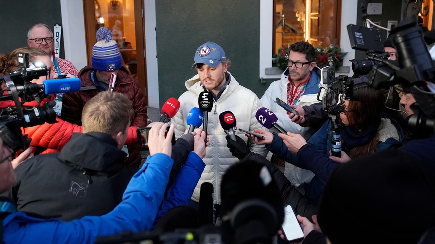 Norway's Atle Lie McGrath, center, meets the media outside his hotel following an alpine ski, men's slalom race, at the 2026 Winter Olympics, in Bormio, Italy, Monday, Feb. 16, 2026. (AP Pho ...