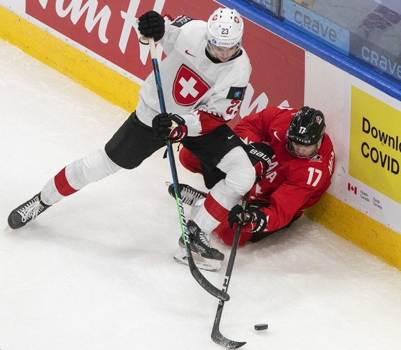 Canada&#039;s Connor McMichael (17) is checked by Switzerland&#039;s Cedric Fiedler (23) during the second period of an IIHF World Junior Hockey Championship game Tuesday, Dec. 29, 2020, in Edmonton,  ...