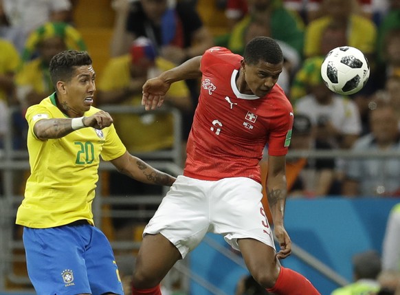 Brazil&#039;s Roberto Firmino, left, and Switzerland&#039;s Manuel Akanji challenge for the ball during the group E match between Brazil and Switzerland at the 2018 soccer World Cup in the Rostov Aren ...