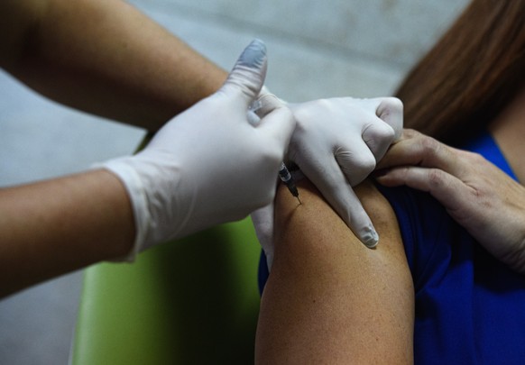 epa08936657 A health care worker receives the first injection of the Moderna COVID-19 vaccine at the Maichin Dom University Hospital in Sofia, Bulgaria, 14 January 2021. EPA/VASSIL DONEV