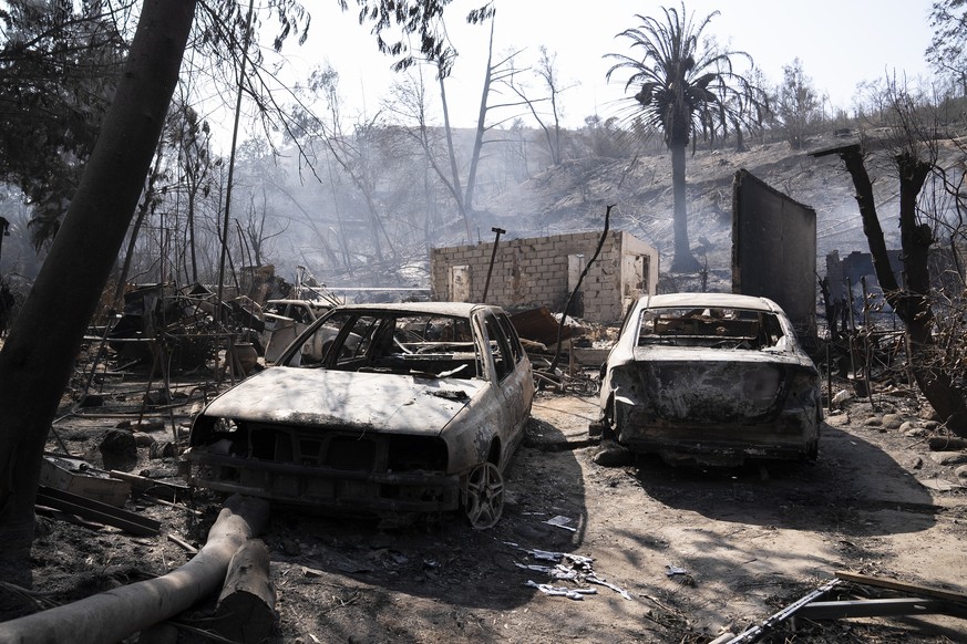 epaselect epa11129809 Burned cars stood outside the destroyed home of Patricia Araya, known as 'La Pati', an employee of the Botanical Garden of Vina del Mar who died in a fire along with her motorcycle...