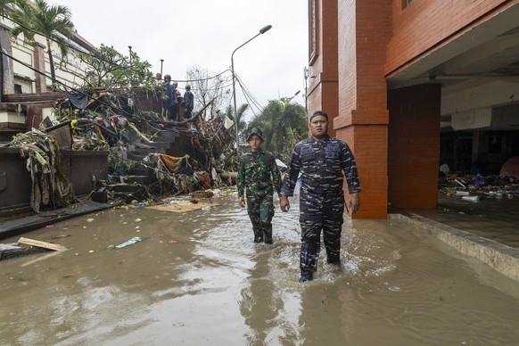 epa12366354 People wade through floodwater at a traditional market in Denpasar, Bali, Indonesia, 10 September 2025. The region has experienced flooding due to days of heavy rain. EPA/MADE NAGI
