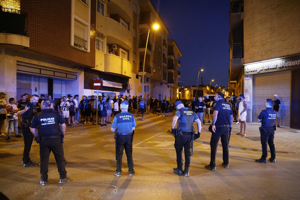 Local police officers and Spanish civil guard agents take positions during the disturbances in Torre Pacheco, eastern Spain, Friday, July 12, 2025. (Mart