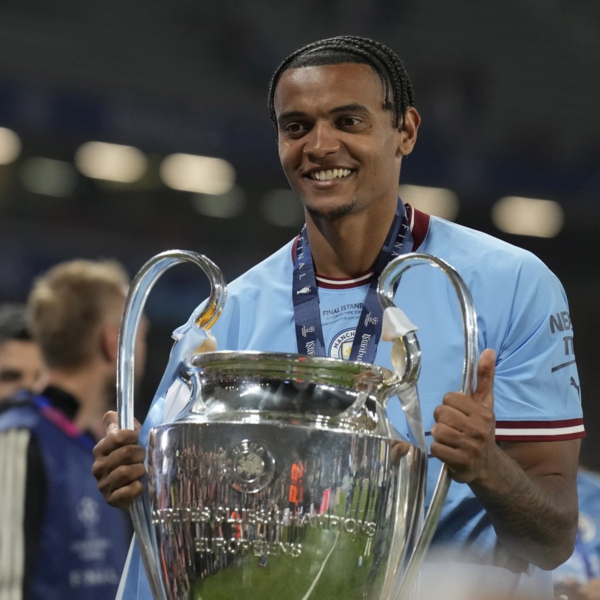 Manchester City's Manuel Akanji celebrates with the trophy after winning the Champions League final soccer match between Manchester City and Inter Milan at the Ataturk Olympic Stadium in Istanbul ...
