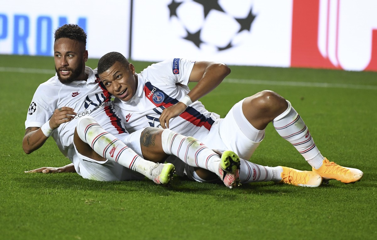 PSG's Neymar, left, celebrates with Kylian Mbappe after teammate Eric Maxim Choupo-Moting scored his team's second goal during the Champions League quarterfinal match between Atalanta and PS ...