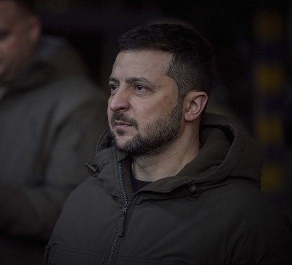 In this photo provided by the Ukrainian Presidential Press Office, Ukrainian President Volodymyr Zelenskyy, looks on as he meets soldiers at the site of the heaviest battles with the Russian invaders  ...