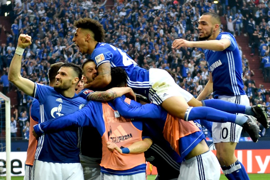 epa06671071 Schalke players celebrate after scoring the 1-0 lead during the German Bundesliga soccer match between FC Schalke 04 and Borussia Dortmund at Veltins-Arena in Gelsenkirchen, Germany, 15 Ap ...