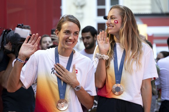 HANDOUT - Nina Brunner, right, and Tanja Hueberli, left, bronze medal winners of the women&#039;s beach volleyball event, celebrate at the reception in the Maison Suisse at the 2024 Paris Summer Olymp ...
