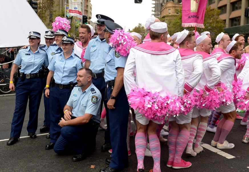 epa04104506 NSW Police pose for photographs with parade goers ahead of the start of the Gay and Lesbian Mardi Gras parade in Sydney, Australia, 01 March 2014. Sydney&#039;s gay and lesbian parade repr ...