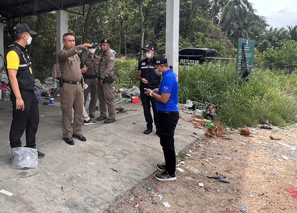 epa10786944 A handout photo made available by the Royal Thai Police shows police officers inspecting a crime scene after finding human body parts at a garbage dump site in Koh Phangan island, Surat Th ...