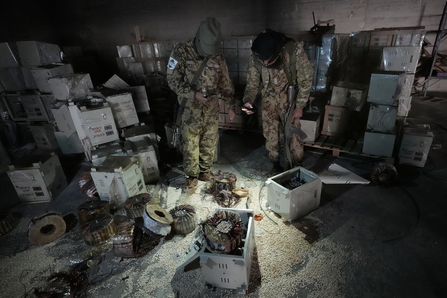Syrian members of the rebel group inspecting electrical components that were used to hide amphetamine pills known as Captagon hidden at the warehouse where the drug was manufactured before the fall of ...