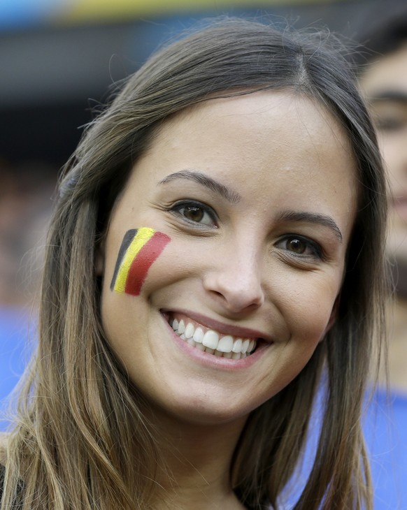 A Belgian fan shows off her national team's colors on her cheek before the group H World Cup soccer match between South Korea and Belgium at the Itaquerao Stadium in Sao Paulo, Brazil, Thursday, June 26, 2014. (AP Photo/Thanassis Stavrakis)
