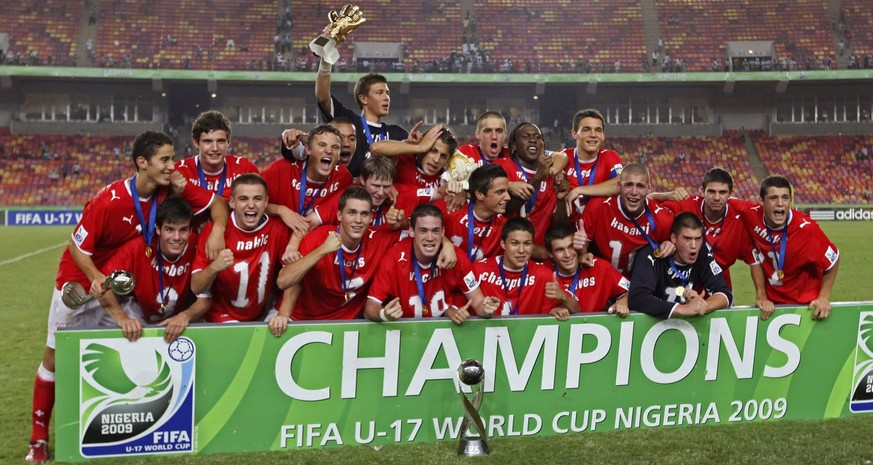 Switzerland Soccer Players react with the trophy, after beating Nigeria during their U17 World Cup soccer Final match, in Abuja, Nigeria Sunday, Nov. 15, 2009. (AP Photo/Sunday Alamba)