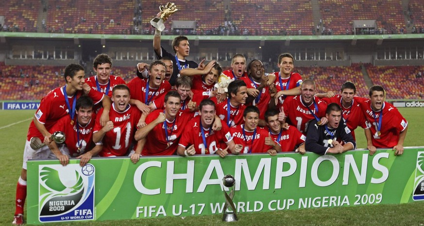Switzerland Soccer Players react with the trophy, after beating Nigeria during their U17 World Cup soccer Final match, in Abuja, Nigeria Sunday, Nov. 15, 2009. (AP Photo/Sunday Alamba)