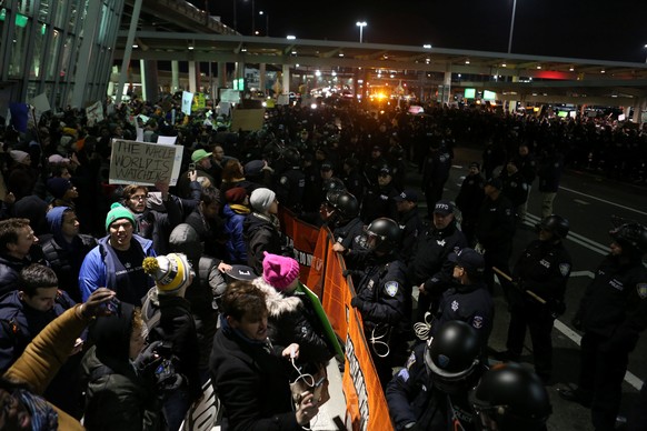Protesters chant slogans outside Terminal 4 at JFK airport in opposition to U.S. President Donald Trump's proposed ban on immigration and travel in Queens, New York City, New York, U.S. January 28, 2017.  REUTERS/Joe Penney