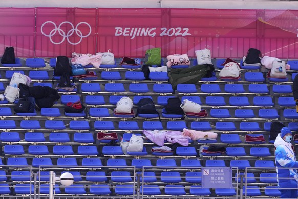 The bags of volunteers on the seats of the stands in the finish area ahead of the men&#039;s downhill at the 2022 Winter Olympics, Sunday, Feb. 6, 2022, in the Yanqing district of Beijing. (AP Photo/D ...