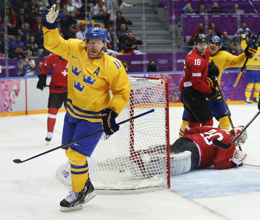Sweden forward Daniel Alfredsson reacts after scoring a goal against Switzerland in the third period of a men's ice hockey game at the 2014 Winter Olympics, Friday, Feb. 14, 2014, in Sochi, Russi ...