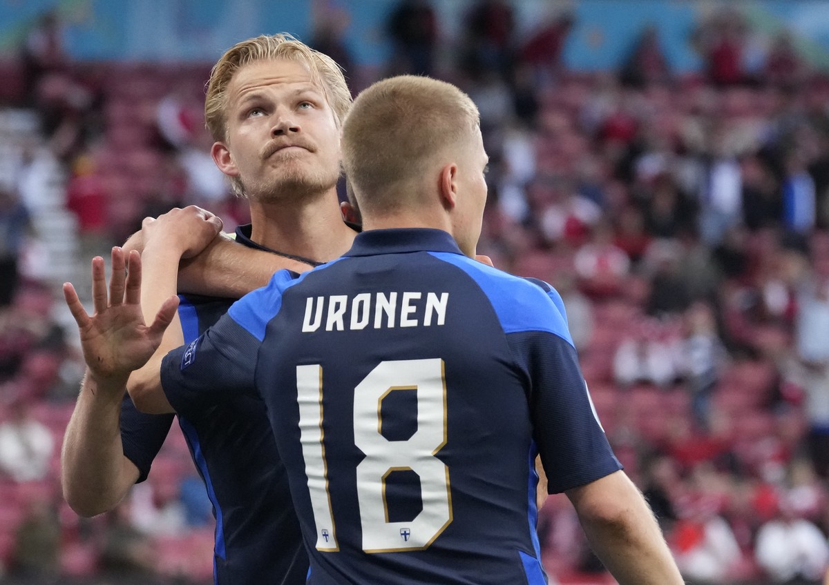 Finland's Joel Pohjanpalo, left, celebrates after scoring his side's opening goal during the Euro 2020 soccer championship group B match between Denmark and Finland at Parken stadium in Cope ...