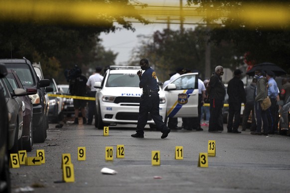 People stand near the scene of a police shooting in Philadelphia, Monday, Oct. 26, 2020, after police officers fatally shot a man during a confrontation. Police officers fatally shot Walter Wallace Jr ...