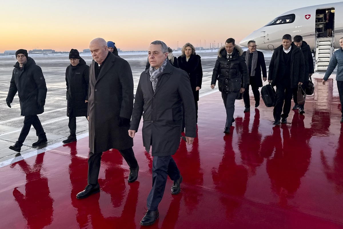HANDOUT - OSCE Chairman-in-Office and Swiss Federal Councillor Ignazio Cassis, center, and OSCE Secretary General Feridun H. Sinirlioglu, center left, arrive at Moscow airport on Thursday, February 5, ...