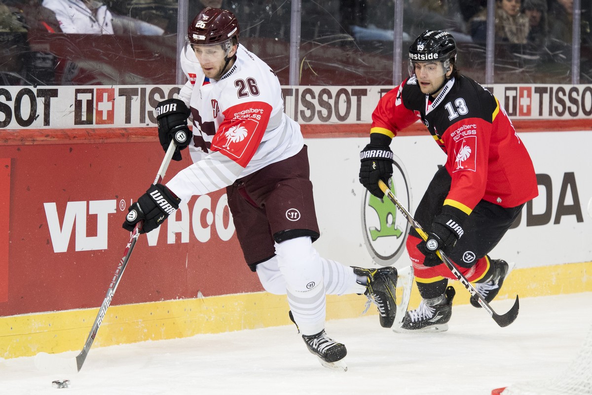 Sparta's Juraj Mikus, left, and Bern's Luca Hischier, right, fight for the puck, during the Champions Hockey League quarter final ice hockey match between Switzerland's SC Bern and Czec ...