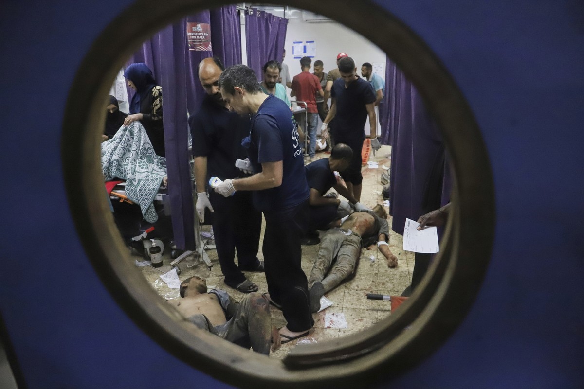 Palestinians who were injured during a food distribution at a center run by the Gaza Humanitarian Foundation, a U.S.-backed organization approved by Israel, receive treatment on the floor of Nasser Ho ...
